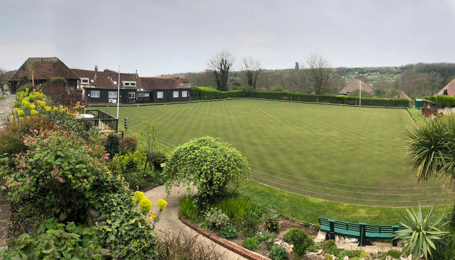 A wide angle photo of the Rottingdean club house, green and garden surrounds